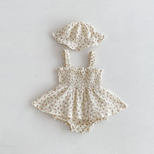 Load image into Gallery viewer, Pink rose print on a textured ivory ground ensure this romper and hat set is stylish and beautiful for summer time. The A-line skirt and shirring to the chest allow for extra comfort. Available in sizes 0-3 years exclusively at Bel Bambini baby boutique.
