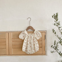 Load image into Gallery viewer, Pink garden floral print romper on a brodeie anglaise fabric base makes this a beautiful style for christenings, parties and special occasions. Bow detail to the front  compliments the puff sleeves and gather details that make this outfit so pretty. Baby and toddler girls must have romper for spring summer. Exclusive styles available from our UK based online store.