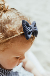Our supersoft hairbands each have a corduroy bow. Available in packs of two, a variety of colours are available to pair with all your little ones outfits.
