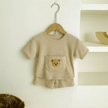 Load image into Gallery viewer, Baby boys summer shorts and t-shirt set. Waffle fabric short sleeved tee and shorts. Cute teddy bear embroidered onto the pocket on the tee. Perfect lounge shorts set for boys aged 0-18 months. Shop exclusve baby clothing at Bel Bambini baby boutique. 
