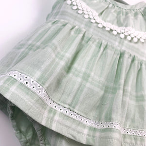 Cotton romper dress in mint green check print. Crochet detailing for girls up to 2 years.