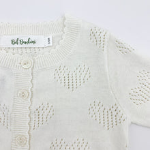 Load image into Gallery viewer, Scallop edging and heart detailing make this baby girls knitted cardigan such a sweet piece to finish off any outfit. Made from cottn yar, soft and comfortable for girls ages 0-24 months. Shop our baby and toddler clothing at Bel Bambini baby boutique.