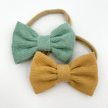 Load image into Gallery viewer, Baby hair accessories, bow headbands for girls in a duo pack. Mustard and mint har bows for babies and toddlers with an elasticated band that is super soft for your little ones head. Available in a variety of colours to match perfectly with your Bel Bambini styles.