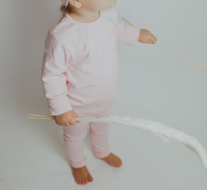 Toddler loungewear available in pink or blue. Super soft cotton set comes with leggings, long sleeve tee and a headband. to match. 0-6m, 6-9m, 9-12m, 12-18m, 18-24m.
