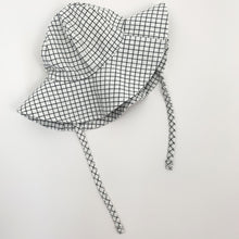 Load image into Gallery viewer, Matching floppy hat for our baby boys romper set. Plaid print in white and black together with a matching romper and a gingham printed shirt. 0-24 month clothing and accessories at Bel Bambini baby boutique.