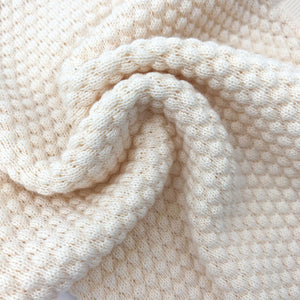 Detail showing our knitted lounge set for girls, Seed knit stitch detailing. Shop our baby and toddler winter knitwear styles online.