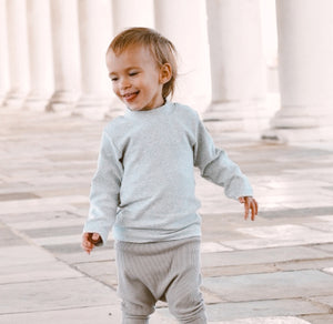 Boys sweater in grey marl. High neck sweater for boys in a beautiful thick and warm fabrication, long sleeved high neck sweater in grey marl. Sizes 0-2 years.