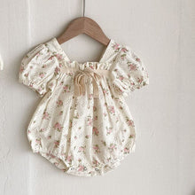 Load image into Gallery viewer, Beautiful clothing for girls, shop our stylish collections. Romper with a contrasting bow and gathered details and puff sleeves in a beautiful pink floral print on a broderie anglaise fabric base makes this perfect for those special  occasions and family gatherings. Shop Bel Bambini baby clothing online.