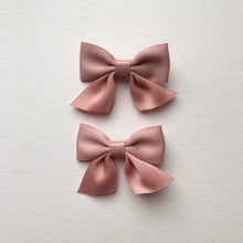Load image into Gallery viewer, Pink satin hair clips for girls, perfect hair accessories for pigtails and cute hairstyles. Available in a red satin also exclusive to Bel Bambini baby boutique.