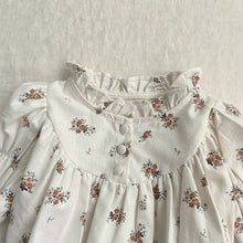 Load image into Gallery viewer, Detail shot of he printed floral romper for girls with gathers, frills and buttons. Shop online today.