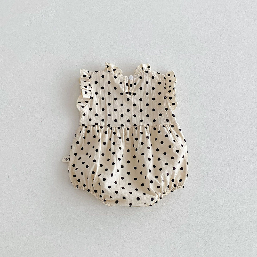 Polka dot romper suit for girls 0-3 years. Frill sleeves and neckline. Gathers to the waist and a button fastening to the back. Perfect one piece outfit for special occasions. Stylish baby and toddler clothing exclusive to Bel Bambini baby and toddler clothing and accessories boutique. UK based online baby and toddler clothing.