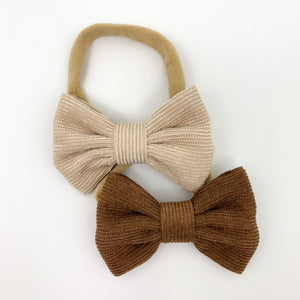 A duo pack of corduroy bow headbands for little girls. Perfect for babies and toddlers, available in a variety of colours. This pack has a latte and a chocolate shade in. Perfect to finish off your Bel Bambini outfits.