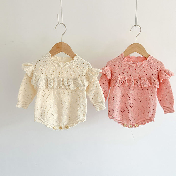 Girls pointelle knitted rompoer with frill detailing, available in two colours, pink or cream. Baby and toddler fashionable yet timeless clothing. 0=2 years clothes and accessories exclusive to Bel Bambini baby and toddler clothing boutique.