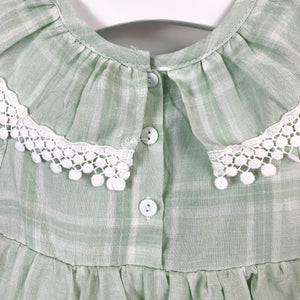 Two button fastenings doen the centre back on our girls romper dress. Summer outfits for baby and toddler girls exclusive to Bel Bambini baby boutique. Shop online today.
