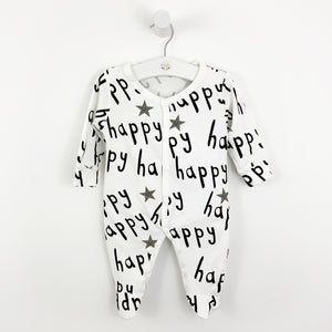 Babygrow, sleepsuit for baby boys and baby girls. Soft and comfortable, this cotton babygrow is white with the text 'happy' printed in black all over the sleepsuit.