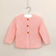 Load image into Gallery viewer, Girls Spanish style knitted cardigan in baby pink, fastened with three wooden buttons.