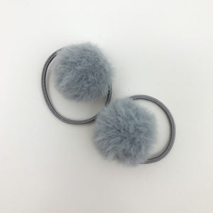 Grey bobbles for girls. Our fluffy pompom bobbles are so dreamy and perfect for styling your little girls hair. Elasticated band for toddler girls and baby girls hair.