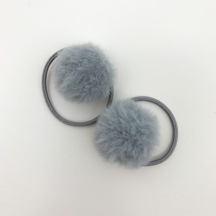 Grey bobbles for girls. Our fluffy pompom bobbles are so dreamy and perfect for styling your little girls hair. Elasticated band for toddler girls and baby girls hair.