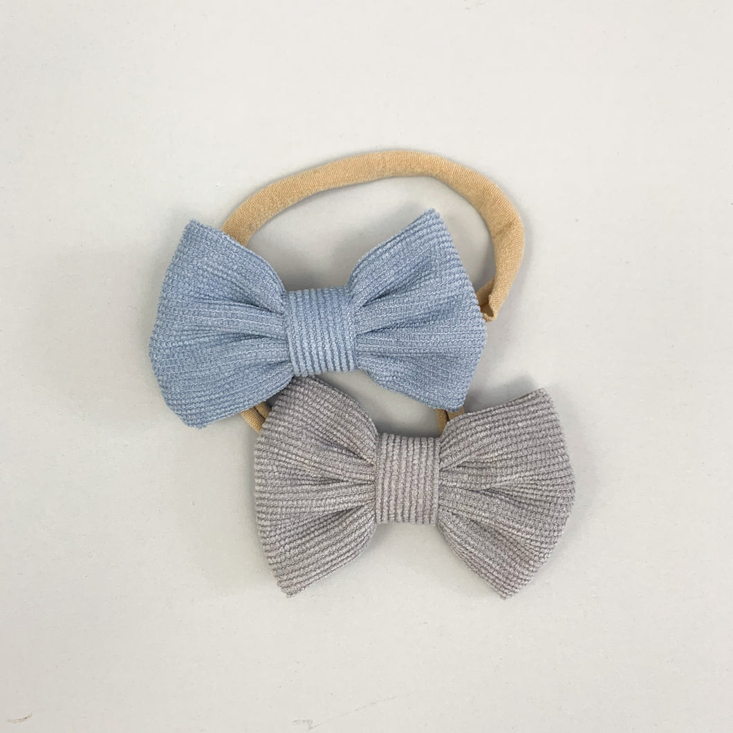 Babt girl headbands. Corduroy bows on an elasticated, super soft band available in a variety of colours.