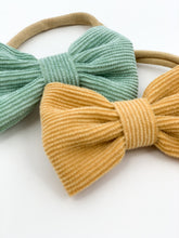 Load image into Gallery viewer, Two pack headbands in mustard and mint for girls. Exclusive to Be bambini baby boutique these corduroy bows are attached to the softest band for extra comfort. Shop girls hair accessories online at Bel Bambini.