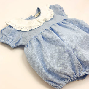 Toddler and baby girls romper made in 100% cotton fabric, short sleeves and a frill collar in a blue gingham print. Cute summer rompers for girls at Bel Bambini baby boutique.
