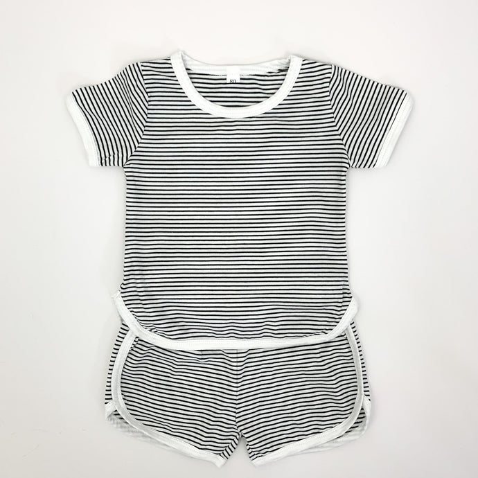 Our Boys shorts and T-shirt set in a black and white stripe. Contrast binding in white. Available in supersoft cotton, this is a perfect summer outfit for toddler boys up to 5 years old. 