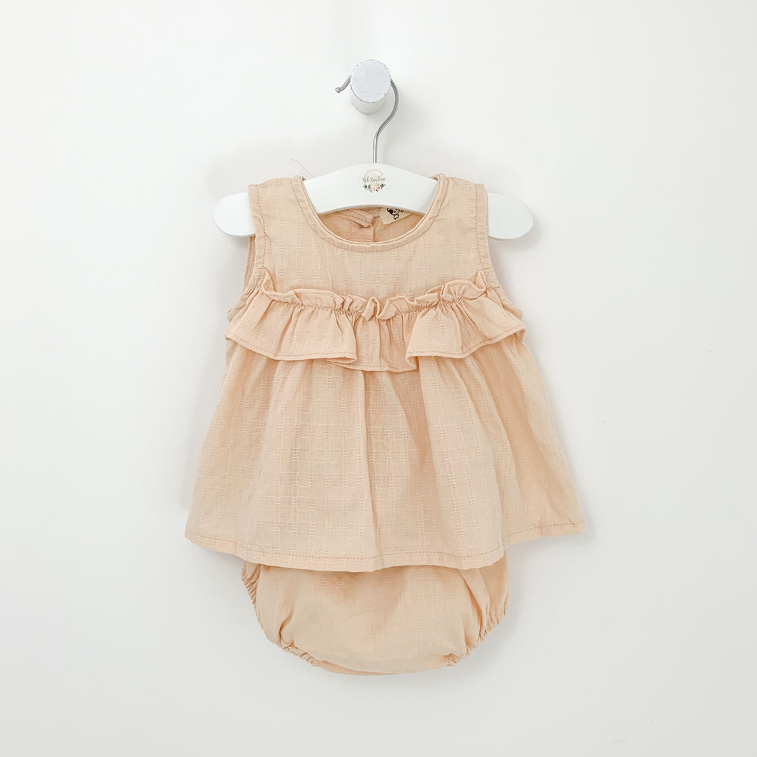 Baby girls summer outfit. A pretty top and bloomers set for girls in nude pink. Ruffles and frills make this a stylish summer set. sizes 0-2 years. Sleeveless top and ruffle bloomers for baby girls.
