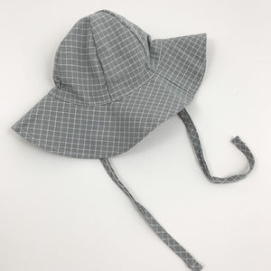 Baby boys summer hat in grey and white with two side straps for easy fastening under the chin if its breezy. Perfect baby boys outfit  at Bel Bambini baby boutique.