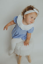 Load image into Gallery viewer, Baby modelling our girls frill romper in blue. Also available in pink and comes with a contrast white headband to match the collar. Spring summer baby and toddler clothing at Bel Bambini baby boutique.