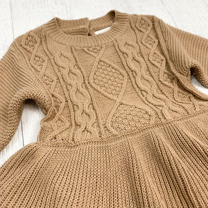 Our girls knitted romper is available in cream or mocha. Perfect essential girls outfit for the autumn winter season. Long sleeves make this warm and cosy. Shop our baby and toddler collections online at Bel Bambini baby boutique.
