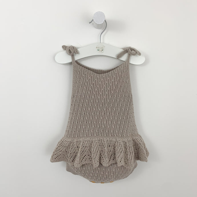 Delicate knitted infant romper. Beatifully stitched with a scallop frill to the waist. Preety knitted romper for girls available in taupe and mauve/ pink. 0-2 years.