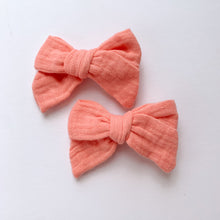 Load image into Gallery viewer, Coral Peach bow hair clips for girls made in a soft cotton linen fabric, matched perfectly to our girls collection outfits. Exclusive to Bel Bambini baby and toddler boutique.