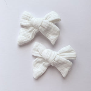 White bow hair clips for girls made in a soft cotton linen fabric, matched perfectly to our girls collection outfits. Exclusive to Bel Bambini baby and toddler boutique. Available in a variety of colours and perefect for pig tails, hair up doos, hair down or just to clip hair back to the side.