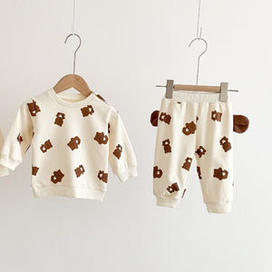 Long sleeved sweater and jogging bottoms for baby girls and baby boys in a teddy bear print. Teddy bear ears feature on each side of the joggers making this lounge set super cute. Exclusive to Bel Bambini baby clothing boutique UK.