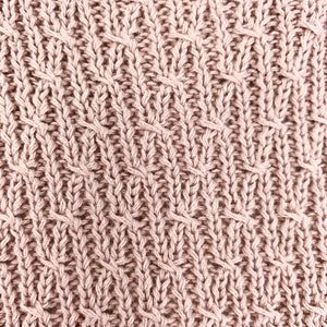 baby knitted romper in dusty pink.
