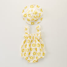 Load image into Gallery viewer, Yellow flower printed romper and hat set for baby girls aged up to 18 months. Perfect for summertime with the lightweight cotton fabrication. Frilly straps and ruched detailing are perfectly stylish for baby girls and super cute together with the matching floppy hat. Shop our girls collections online at Bel Bambini baby boutique.
