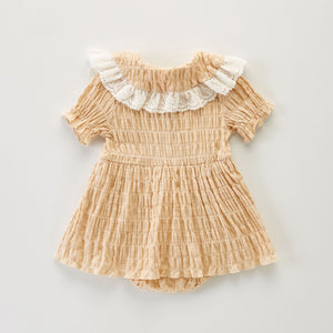 Showing the back of our baby and toddler girls romper dress. Beautiful, timeless clothing for babies and toddlers.