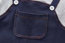 Load image into Gallery viewer, Pocket detail photo of the front of our boys dungaree style romper. 0=6 months, 6-9 months, 9-12 months, 12-18 months, 18-24 months.