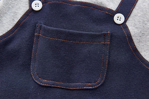 Pocket detail photo of the front of our boys dungaree style romper. 0=6 months, 6-9 months, 9-12 months, 12-18 months, 18-24 months.