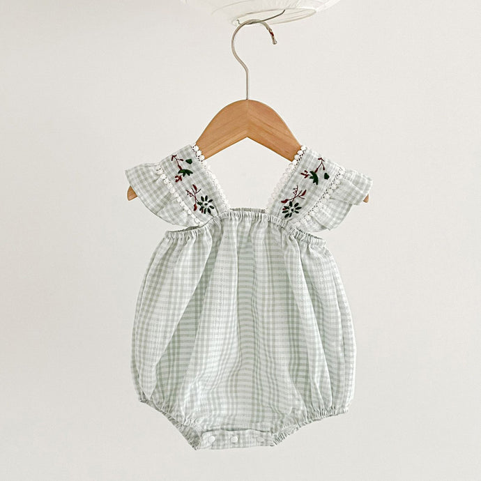 Gingham romper for girls with beautiful lace trims, emroidered flowers and frills. Comes in a lightweight cotton to keep your little one cool in summertime. 0-2 years exclusively at Bel Bambini baby and toddler clothing boutique. Our UK based online boutique offers stylish clothing and accessories for babies and toddlers.